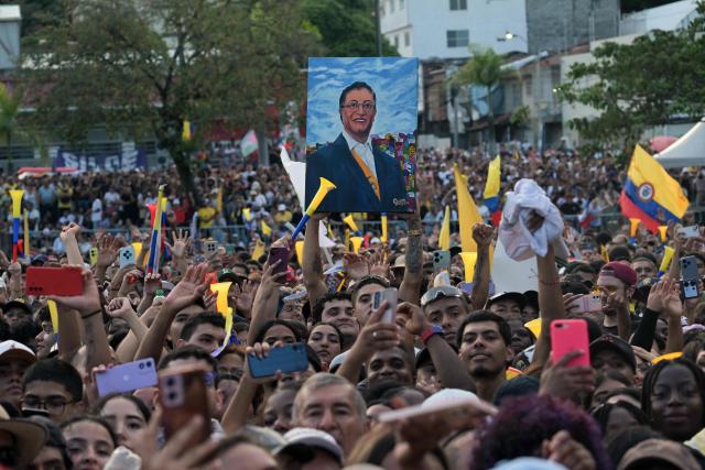 A supporter of Colombia's President Gustavo Petro holds a portrait depicting him during a rally in Cali, Colombia, on June 19, 2026, two days ahead of the presidential runoff. Colombians vote on June 21, 2026 in a presidential runoff pitting a hard-right opera-singer-turned-lawyer against a leftist senator, an election with stark consequences for the country's stumbling peace process with armed groups and strained ties with Washington. (Photo by JOAQUIN SARMIENTO / AFP)