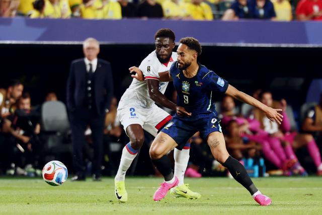 Haiti's defender #02 Carlens Arcus and Brazil's forward #09 Matheus Cunha fight for the ball during the 2026 World Cup Group C football match between Brazil and Haiti at the Philadelphia Stadium in Philadelphia on June 19, 2026.  (Photo by Charly TRIBALLEAU / AFP)