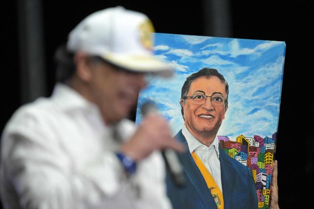 Colombia's President Gustavo Petro speaks next to a portrait depicting him during a rally in Cali, Colombia, on June 19, 2026, two days ahead of the presidential runoff. Colombians vote on June 21, 2026 in a presidential runoff pitting a hard-right opera-singer-turned-lawyer against a leftist senator, an election with stark consequences for the country's stumbling peace process with armed groups and strained ties with Washington. (Photo by JOAQUIN SARMIENTO / AFP)