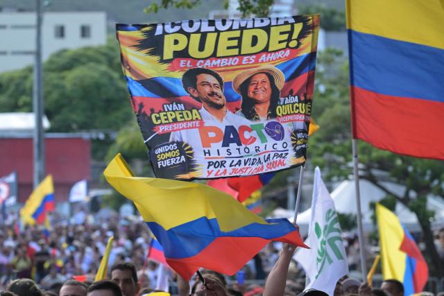 Supporters of Colombia's President Gustavo Petro display a banner featuring presidential candidate Ivan Cepeda and running mate Aida Quilcue of the Pacto Historico party during a rally in Cali, Colombia, on June 19, 2026, two days ahead of the presidential runoff. Colombians vote on June 21, 2026 in a presidential runoff pitting a hard-right opera-singer-turned-lawyer against a leftist senator, an election with stark consequences for the country's stumbling peace process with armed groups and strained ties with Washington. (Photo by JOAQUIN SARMIENTO / AFP)