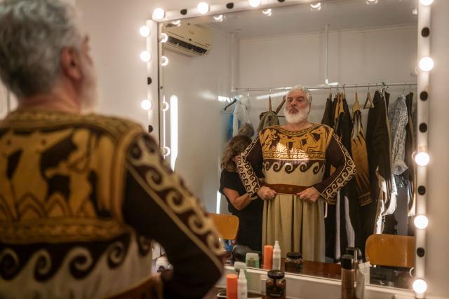 Greek operatic baritone Tassis Christoyannis prepares backstage to perform in the opera 'Medea' at the Ancient Greek theatre of former city Epidaurus, in Nea Epidavros on June 18, 2026. With flamboyant costumes reminiscent of those from 1961, and a production reconstructed using notebooks and photographs from the period: 'Medea', the opera that brought Maria Callas her triumph, is being revived at the ancient Greek theatre of Epidaurus. During a one-off, sold-out performance on Saturday evening, the Greek National Opera returns for the first time in 65 years to this 4th-century BC amphitheatre, 200 kilometres from Athens, renowned for its exceptional acoustics. (Photo by Aris MESSINIS / AFP)