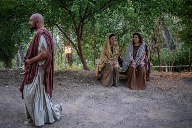 Actors dressed as Ancient Greeks wait backstage to perform in the opera 'Medea' at the Ancient Greek theatre of former city Epidaurus, in Nea Epidavros on June 18, 2026. With flamboyant costumes reminiscent of those from 1961, and a production reconstructed using notebooks and photographs from the period: 'Medea', the opera that brought Maria Callas her triumph, is being revived at the ancient Greek theatre of Epidaurus. During a one-off, sold-out performance on Saturday evening, the Greek National Opera returns for the first time in 65 years to this 4th-century BC amphitheatre, 200 kilometres from Athens, renowned for its exceptional acoustics. (Photo by Aris MESSINIS / AFP)