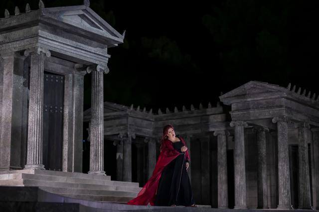 Italian soprano Anna Pirozzi performs in the opera 'Medea' at the Ancient Greek theatre of former city Epidaurus, in Nea Epidavros on June 18, 2026. With flamboyant costumes reminiscent of those from 1961, and a production reconstructed using notebooks and photographs from the period: 'Medea', the opera that brought Maria Callas her triumph, is being revived at the ancient Greek theatre of Epidaurus. During a one-off, sold-out performance on Saturday evening, the Greek National Opera returns for the first time in 65 years to this 4th-century BC amphitheatre, 200 kilometres from Athens, renowned for its exceptional acoustics. (Photo by Aris MESSINIS / AFP)