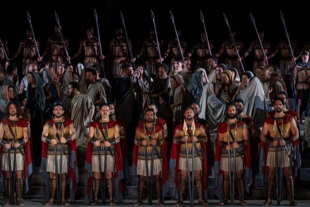 Opera singers and actors perform in the opera 'Medea' at the Ancient Greek theatre of former city Epidaurus, in Nea Epidavros on June 18, 2026. With flamboyant costumes reminiscent of those from 1961, and a production reconstructed using notebooks and photographs from the period: 'Medea', the opera that brought Maria Callas her triumph, is being revived at the ancient Greek theatre of Epidaurus. During a one-off, sold-out performance on Saturday evening, the Greek National Opera returns for the first time in 65 years to this 4th-century BC amphitheatre, 200 kilometres from Athens, renowned for its exceptional acoustics. (Photo by Aris MESSINIS / AFP)
