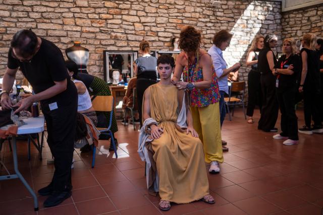 An actor prepares backstage to perform in the opera 'Medea' at the Ancient Greek theatre of former city Epidaurus, in Nea Epidavros on June 18, 2026. With flamboyant costumes reminiscent of those from 1961, and a production reconstructed using notebooks and photographs from the period: 'Medea', the opera that brought Maria Callas her triumph, is being revived at the ancient Greek theatre of Epidaurus. During a one-off, sold-out performance on Saturday evening, the Greek National Opera returns for the first time in 65 years to this 4th-century BC amphitheatre, 200 kilometres from Athens, renowned for its exceptional acoustics. (Photo by Aris MESSINIS / AFP)