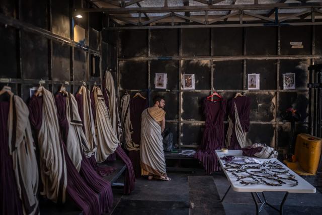 An actor prepares backstage to perform in the opera 'Medea' at the Ancient Greek theatre of former city Epidaurus, in Nea Epidavros on June 18, 2026. With flamboyant costumes reminiscent of those from 1961, and a production reconstructed using notebooks and photographs from the period: 'Medea', the opera that brought Maria Callas her triumph, is being revived at the ancient Greek theatre of Epidaurus. During a one-off, sold-out performance on Saturday evening, the Greek National Opera returns for the first time in 65 years to this 4th-century BC amphitheatre, 200 kilometres from Athens, renowned for its exceptional acoustics. (Photo by Aris MESSINIS / AFP)