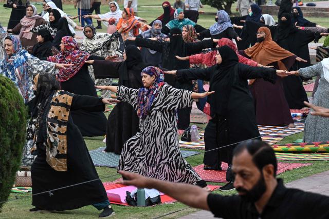 Muslim women take part in a yoga practice session on the eve of the International Yoga Day in Lahore on June 20, 2026. (Photo by Arif ALI / AFP)