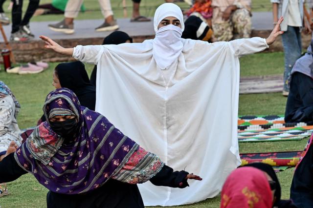 Muslim women take part in a yoga practice session on the eve of the International Yoga Day in Lahore on June 20, 2026. (Photo by Arif ALI / AFP)