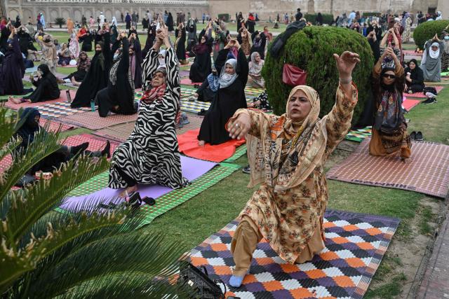Muslim women take part in a yoga practice session on the eve of the International Yoga Day in Lahore on June 20, 2026. (Photo by Arif ALI / AFP)
