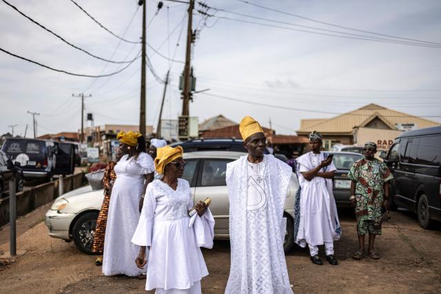 Guests stand outside the venue during the traditional wedding ceremony of twin brothers Taiwo and Kehinde Oguntoye and twin sisters Taiwo and Kehinde Adediran at the RAD Events Hall in Ibadan, on June 19, 2026. (Photo by OLYMPIA DE MAISMONT / AFP)