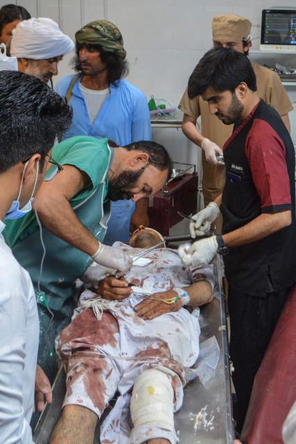 Paramedics attend to an injured victim of twin roadside blasts at a hospital in Bannu on June 20, 2026. Twin roadside blasts killed at least seven people in Pakistan's northwest Khyber Pakhtunkhwa province, police said on June 20. (Photo by Karim ULLAH / AFP)