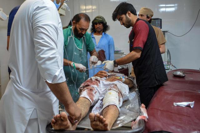 EDITORS NOTE: Graphic content / Paramedics attend to an injured victim of twin roadside blasts at a hospital in Bannu on June 20, 2026. Twin roadside blasts killed at least seven people in Pakistan's northwest Khyber Pakhtunkhwa province, police said on June 20. (Photo by Karim ULLAH / AFP)