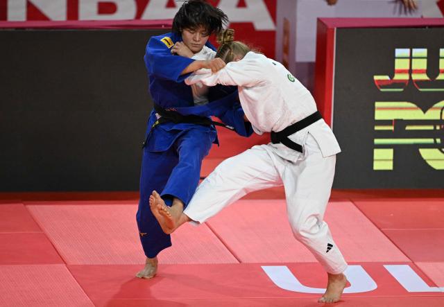 Shiho Tanaka of Japan (blue) competes with Margit de Voogd of the Netherlands (white) in their semi final for women under 70kg at the Judo Ulaanbaatar Grand Slam 2026 in Ulaanbaatar on June 20, 2026. (Photo by ADEK BERRY / AFP)