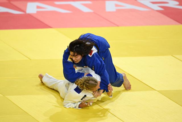 Shiho Tanaka of Japan (blue) competes with Margit de Voogd of the Netherlands (white) in their semi final for women under 70kg at the Judo Ulaanbaatar Grand Slam 2026 in Ulaanbaatar on June 20, 2026. (Photo by ADEK BERRY / AFP)