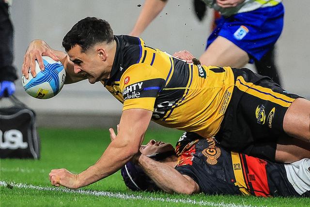 Hurricanes Josh Moorby dives in to score a try during the Super Rugby Pacific final match between the Wellington Hurricanes and Waikato Chiefs in Wellington on June 20, 2026. (Photo by Grant Down / AFP)