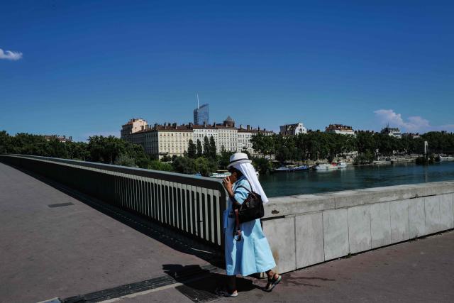 A pedestrian walks during a heatwave in Lyon, south-eastern France on June 18, 2026. (Photo by OLIVIER CHASSIGNOLE / AFP)