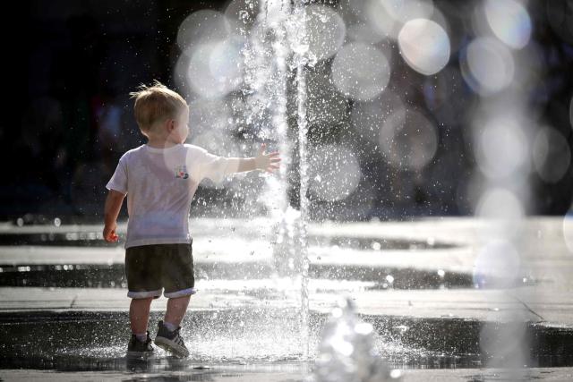 A child plays in a fountain during a heatwave in Lyon, south-eastern France on June 18, 2026. (Photo by OLIVIER CHASSIGNOLE / AFP)