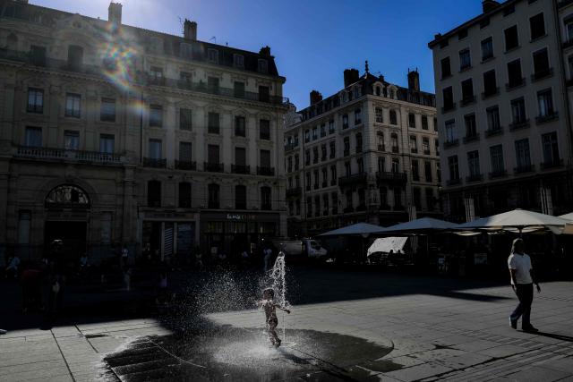 A child plays in a fountain during a heatwave in Lyon, south-eastern France on June 18, 2026. (Photo by OLIVIER CHASSIGNOLE / AFP)