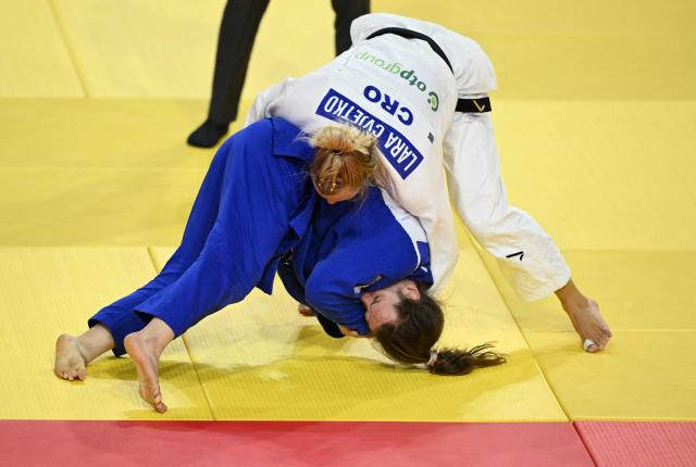 Clemence Eme of France (blue) competes with Lara Cvjetko of Croatia (white) in their repechage event for women under 70kg at the Judo Ulaanbaatar Grand Slam 2026 in Ulaanbaatar on June 20, 2026. (Photo by ADEK BERRY / AFP)
