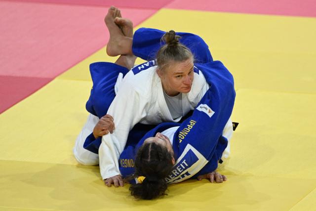 Miriam Butkereit of Germany (blue) competes with Aoife Coughlan of Australia (white) in their semi-final for women under 70kg at the Judo Ulaanbaatar Grand Slam 2026 in Ulaanbaatar on June 20, 2026. (Photo by ADEK BERRY / AFP)