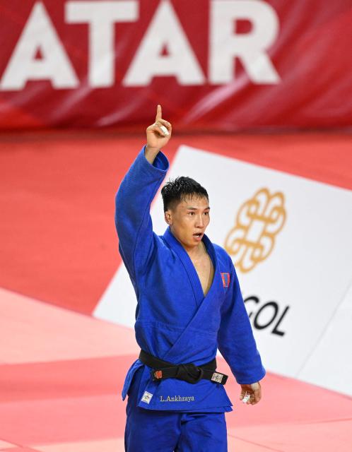 Ankhzaya Lavjargal of Mongolia (blue) reacts after winning against Irakli Goginashvili of Britain (white) in their semi-final for men under 73kg at the Judo Ulaanbaatar Grand Slam 2026 in Ulaanbaatar on June 20, 2026. (Photo by ADEK BERRY / AFP)