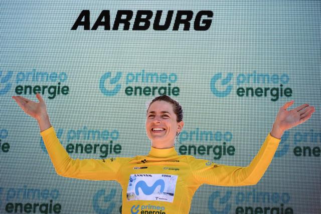 Switzerland's Marlen Reusser wearing the overall leader's yellow jersey celebrates on the podium after winning in the fourth stage, a 23,7 km time trial from Aarburg to Aarburg, at the Women’s Tour of Switzerland (Tour de Suisse) cycling race in Aarburg, Switzerland, on June 20, 2026. (Photo by Fabrice COFFRINI / AFP)