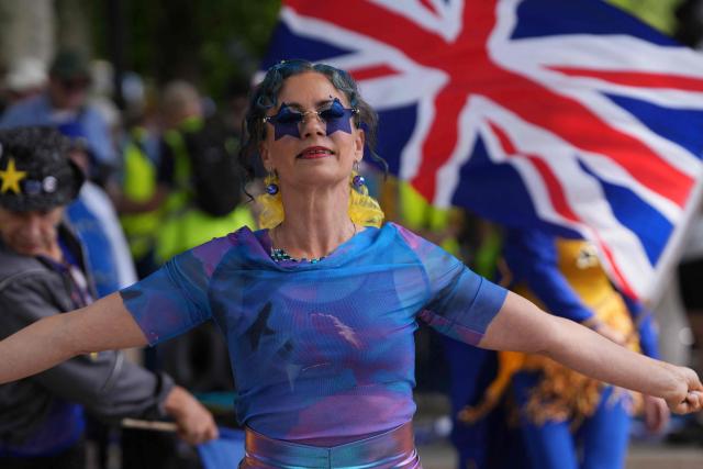 Protesters wave flags during a National 'rejoin the EU' march in central London on June 20, 2026. (Photo by CARLOS JASSO / AFP)
