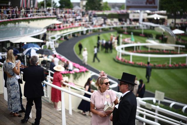 Racegoers mingle ahead of racing on the fifth day of the Royal Ascot horse racing meeting in Ascot, west of London, on June 20, 2026. (Photo by Henry Nicholls / AFP)