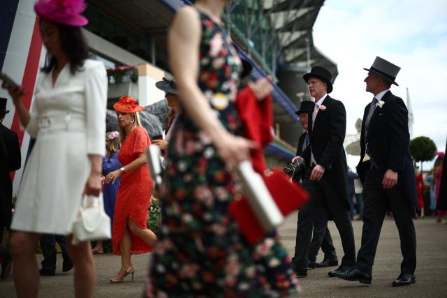 Racegoers mingle ahead of racing on the fifth day of the Royal Ascot horse racing meeting in Ascot, west of London, on June 20, 2026. (Photo by Henry Nicholls / AFP)