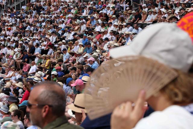 Spectators in the packed grandstand watch the first men's singles semi-final tennis match on day six of the ATP HSBC Championships at Queen's Club in west London on June 20, 2026. (Photo by Adrian DENNIS / AFP)