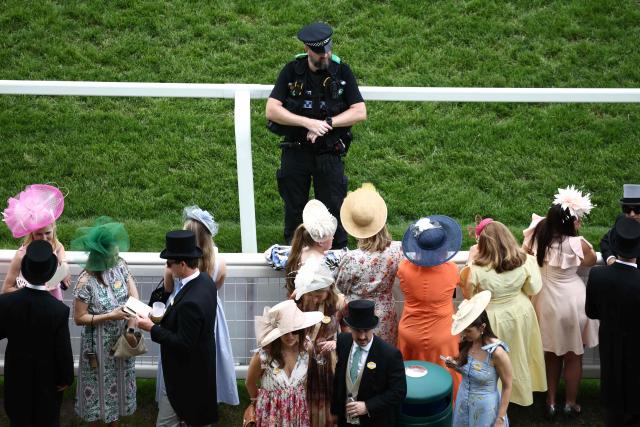 A police officer keeps watch over the racegoers ahead of racing on the fifth day of the Royal Ascot horse racing meeting in Ascot, west of London, on June 20, 2026. (Photo by Henry NICHOLLS / AFP)