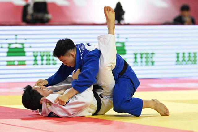 Lee Joon-hwan of South Korea (L) and Yuhei Oino of Japan compete during the men's under 81kg final event at the Judo Ulaanbaatar Grand Slam 2026 in Ulaanbaatar, Mongolia on June 20, 2026. (Photo by ADEK BERRY / AFP)