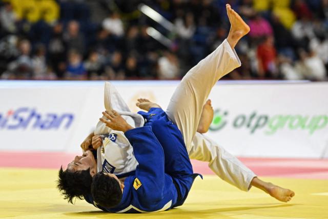 Lee Joon-hwan of South Korea (top) and Yuhei Oino of Japan compete during the men's under 81kg final event at the Judo Ulaanbaatar Grand Slam 2026 in Ulaanbaatar, Mongolia on June 20, 2026. (Photo by ADEK BERRY / AFP)