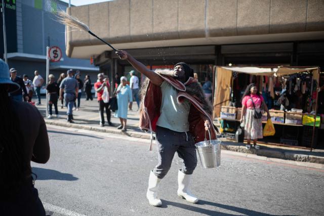 A group of about 100 people, some carrying banners and waving South African flags, take part in a march, organised by the March and March movement, protesting against illegal immigrants, in Wynberg, a Cape Town suburb, on June 20, 2026. (Photo by RODGER BOSCH / AFP)