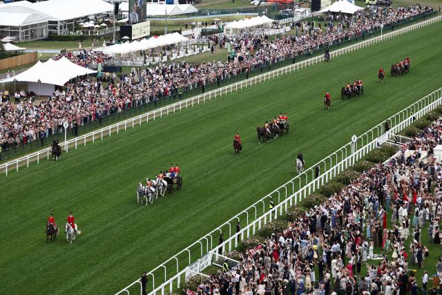 Britain's King Charles III and Britain's Queen Camilla and other members of the Royal Family arrive by horse-drawn carriage on the fifth day of the Royal Ascot horse racing meeting in Ascot, west of London, on June 20, 2026. (Photo by Henry Nicholls / AFP)