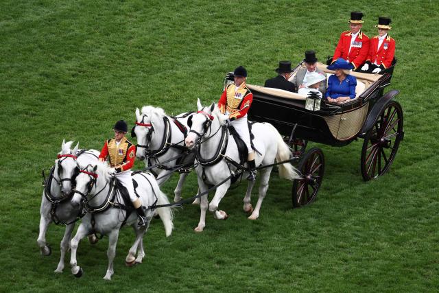 Britain's King Charles III and Britain's Queen Camilla arrive by horse-drawn carriage on the fifth day of the Royal Ascot horse racing meeting in Ascot, west of London, on June 20, 2026. (Photo by Henry Nicholls / AFP)