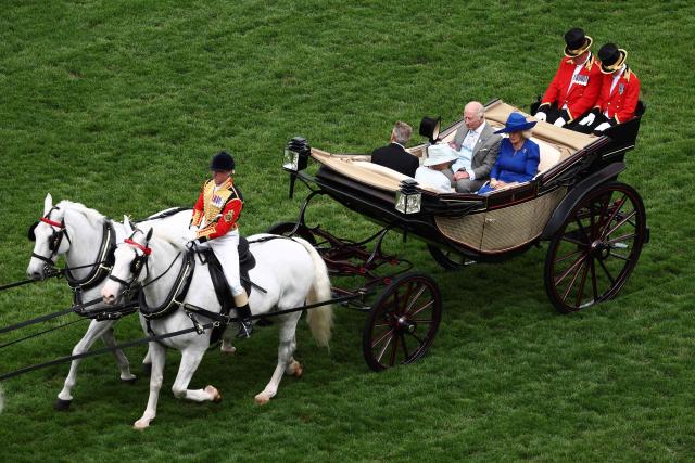 Britain's King Charles III and Britain's Queen Camilla arrive by horse-drawn carriage on the fifth day of the Royal Ascot horse racing meeting in Ascot, west of London, on June 20, 2026. (Photo by Henry Nicholls / AFP)