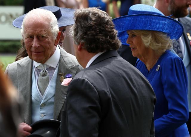 Britain's King Charles III talks with Fancis Brooke on the fifth day of the Royal Ascot horse racing meeting in Ascot, west of London, on June 20, 2026. (Photo by Henry Nicholls / AFP)