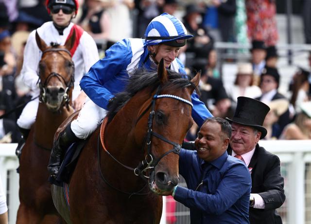 Jockey Tom Marquand celebrates on Almeraq with Richard Hills (R), after riding to win the Queen Elizabeth II Jubilee Stakes horse race on the fifth day of the Royal Ascot horse racing meeting in Ascot, west of London, on June 20, 2026. (Photo by Henry NICHOLLS / AFP)