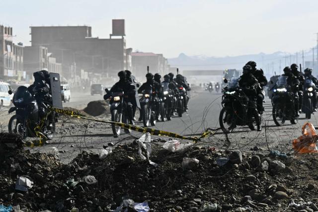 Police officers are deployed at a blockade zone in Cruce Ventilla, El Alto, Bolivia on June 20, 2026, after Bolivian president Rodrigo Paz declared state of emergency. Bolivian President Rodrigo Paz declared a state of emergency across the Latin American country after more than six weeks of road blockades and protests demanding his resignation, saying he had exhausted "all avenues of dialogue." (Photo by AIZAR RALDES / AFP)