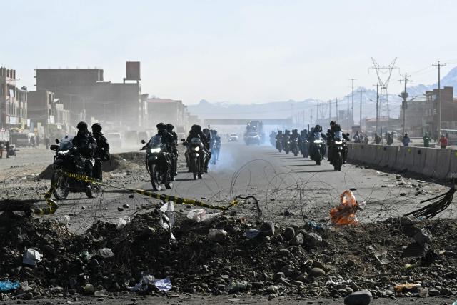 Police officers are deployed at a blockade zone in Cruce Ventilla, El Alto, Bolivia on June 20, 2026, after Bolivian president Rodrigo Paz declared state of emergency. Bolivian President Rodrigo Paz declared a state of emergency across the Latin American country after more than six weeks of road blockades and protests demanding his resignation, saying he had exhausted "all avenues of dialogue." (Photo by AIZAR RALDES / AFP)