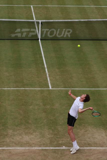 France's Ugo Humbert serves to US player Tommy Paul during their men's singles semi-final tennis match on day six of the ATP HSBC Championships at Queen's Club in west London on June 20, 2026. (Photo by Adrian Dennis / AFP)