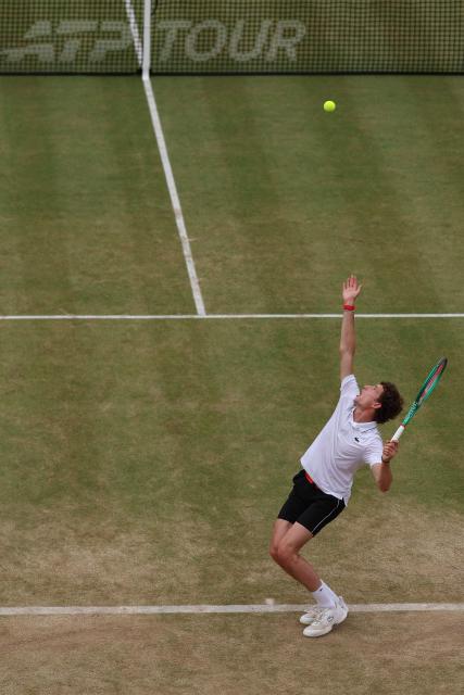 France's Ugo Humbert serves to US player Tommy Paul during their men's singles semi-final tennis match on day six of the ATP HSBC Championships at Queen's Club in west London on June 20, 2026. (Photo by Adrian Dennis / AFP)