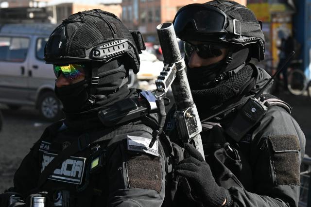 Police officers are deployed at a blockade zone in Cruce Ventilla, El Alto, Bolivia on June 20, 2026, after Bolivian president Rodrigo Paz declared state of emergency. Bolivian President Rodrigo Paz declared a state of emergency across the Latin American country after more than six weeks of road blockades and protests demanding his resignation, saying he had exhausted "all avenues of dialogue." (Photo by AIZAR RALDES / AFP)