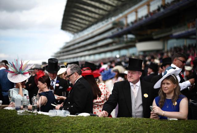 Racegoers wait for a a race to start on the fifth day of the Royal Ascot horse racing meeting in Ascot, west of London, on June 20, 2026. (Photo by Henry Nicholls / AFP)