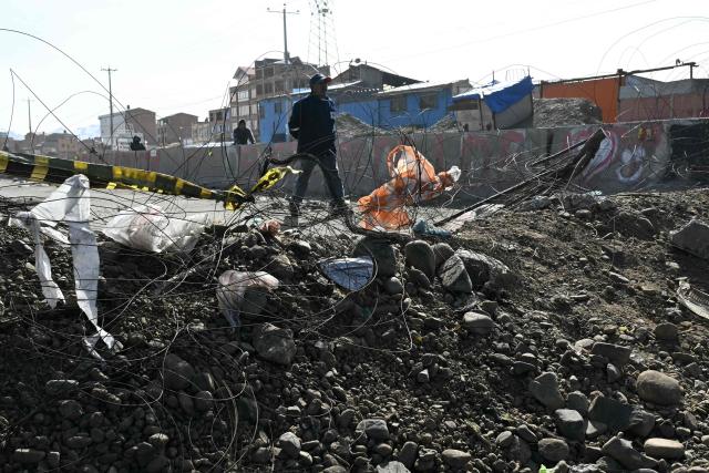 View of a barricade at a blockade zone in Cruce Ventilla in El Alto, Bolivia on June 20, 2026, after Bolivian president Rodrigo Paz declared state of emergency. Bolivian President Rodrigo Paz declared a state of emergency across the Latin American country after more than six weeks of road blockades and protests demanding his resignation, saying he had exhausted "all avenues of dialogue." (Photo by AIZAR RALDES / AFP)