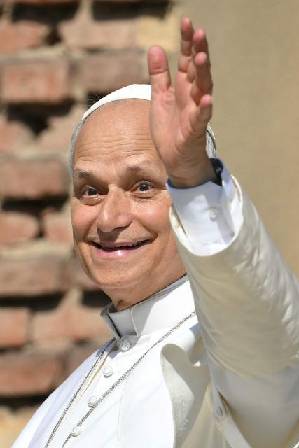 Pope Leo XIV waves from the entrance of the cathedral during a pastoral visit in Pavia on June 20, 2026. (Photo by Marco BERTORELLO / AFP)