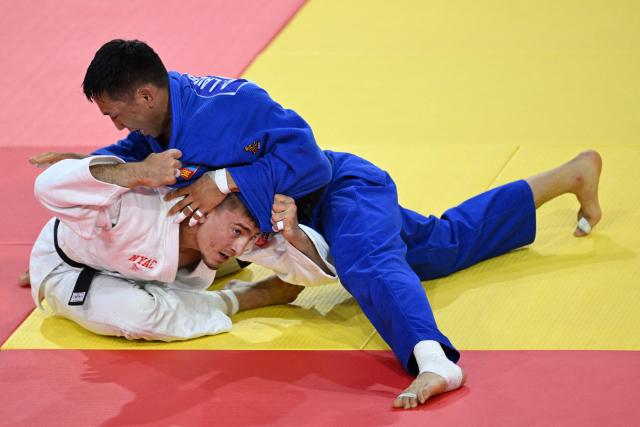 Jack Yonezuka (L) of USA and Ankhzaya Lavjargal of Mongolia compete during the men's under 73kg final event at the Judo Ulaanbaatar Grand Slam 2026 in Ulaanbaatar, Mongolia on June 20, 2026. (Photo by ADEK BERRY / AFP)