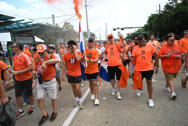 Netherlands supporters burn flares as they make their way to the venue to attend a the 2026 World Cup Group F football match between the Netherlands and Sweden at the Houston Stadium in Houston on June 20, 2026.  (Photo by Paul ELLIS / AFP)