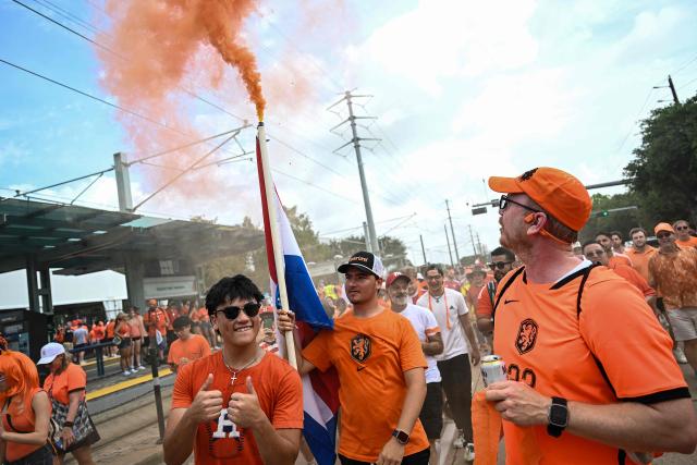 Netherlands supporters burn flares as they make their way to the venue to attend a the 2026 World Cup Group F football match between the Netherlands and Sweden at the Houston Stadium in Houston on June 20, 2026.  (Photo by Paul ELLIS / AFP)